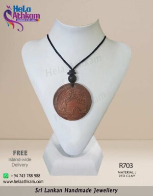 Handmade red clay pendant with elephant engraving in it.