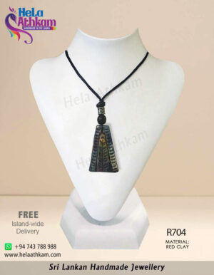 Red clay pendant made by hand with triangular shape and simple engraving on it.