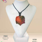 Handmade red clay pendant that looks like a dry leaf.