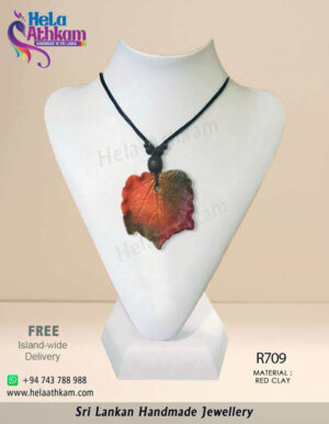 Handmade red clay pendant that looks like a dry leaf.