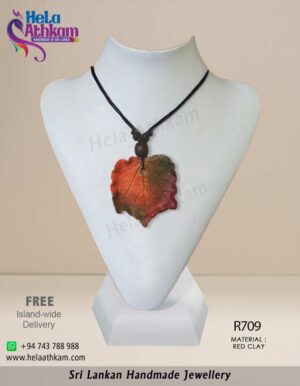 Handmade red clay pendant that looks like a dry leaf.