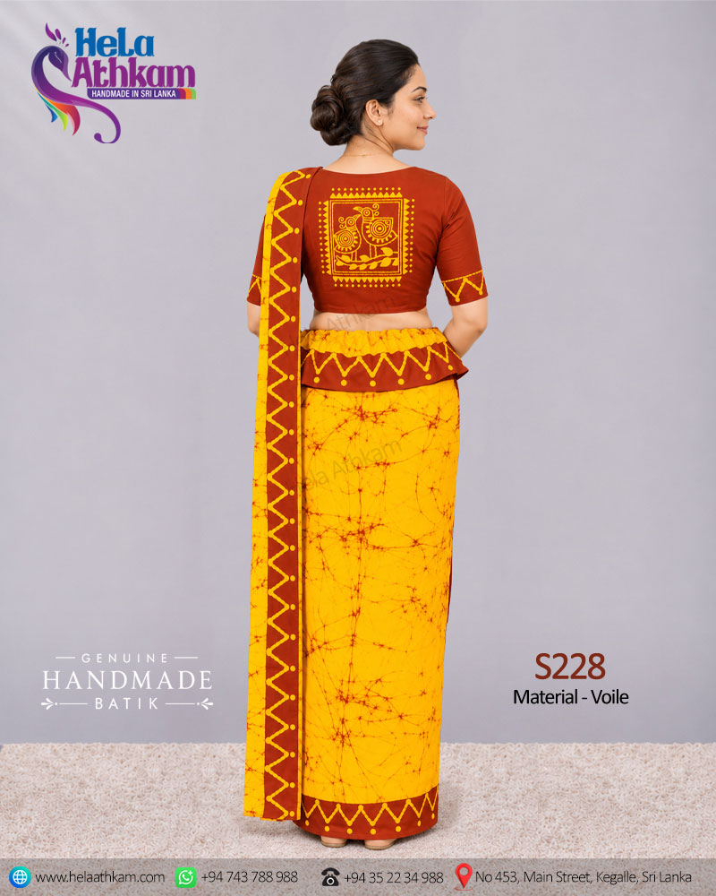 Sri Lankan handmade batik osariya made by Hela Athkam using golden yellow and brown colors back view.